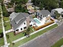 Stunning aerial view showcases backyard oasis with a sparkling pool, privacy fence, and lush greenery at 2101 3Rd N Ave, St Petersburg, FL 33713