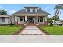 Charming single-Gathering home features a covered front porch, brick accents, and manicured landscaping at 2101 3Rd N Ave, St Petersburg, FL 33713