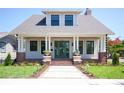Charming two-story home with a welcoming front porch, lush lawn, and manicured landscaping at 2101 3Rd N Ave, St Petersburg, FL 33713