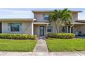 Cozy home with a well-manicured lawn, mature landscaping, and blue shutters enhancing the curb appeal at 2131 Ridge S Rd # 3, Largo, FL 33778