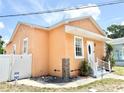 Charming single-story home featuring a stucco exterior, inviting front entrance, and well-maintained landscaping at 2137 W Saint Louis St, Tampa, FL 33607