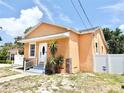 Charming single-story home featuring a stucco exterior, inviting front entrance, and well-maintained landscaping at 2137 W Saint Louis St, Tampa, FL 33607