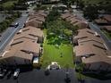 Aerial view of condos with mature trees and well maintained landscaping in the common areas at 2335 Beneva Ter # 2254, Sarasota, FL 34232