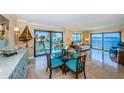 Bright living space with comfortable seating, water views, and access to the balcony at 240 Sand Key Estates Dr # 222, Clearwater, FL 33767