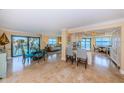 Open-concept living and dining area with large windows offering stunning water views at 240 Sand Key Estates Dr # 222, Clearwater, FL 33767