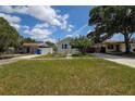 Well-kept home with a manicured lawn, mature trees, and tranquil neighborhood surroundings at 2627 17Th N Ave, St Petersburg, FL 33713