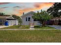 Cozy white home with a minimalist facade, complemented by the trees in the front yard at 2627 17Th N Ave, St Petersburg, FL 33713