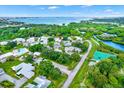 Aerial view of the community showcasing lush landscaping, community pool, and waterfront views at 3229 40Th S Ln # C, St Petersburg, FL 33711