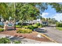 Community entrance to West Shore Village featuring a sign, beautiful landscaping and gate at 3229 40Th S Ln # C, St Petersburg, FL 33711
