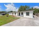 Front view of freshly painted single-story home with driveway and manicured landscaping at 4812 El Capistrano Dr, Tampa, FL 33634