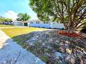 Charming single-story home featuring a long driveway, well-maintained lawn and mature landscaping at 5817 Liverpool Dr, Tampa, FL 33615