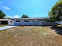 Charming single-story home featuring a long driveway, well-maintained lawn and mature landscaping at 5817 Liverpool Dr, Tampa, FL 33615