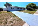 Charming single-story home featuring a long driveway, well-maintained lawn and mature landscaping at 5817 Liverpool Dr, Tampa, FL 33615
