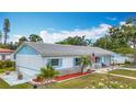 Beautiful home showcasing gray roof, stone accents, fresh landscaping, and a manicured lawn at 6350 18Th N Ave, St Petersburg, FL 33710