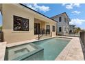 Backyard pool with integrated hot tub and luxurious patio ideal for relaxation or entertaining guests at 6532 Simone Shores Cir, Apollo Beach, FL 33572