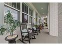 Inviting front porch with rocking chairs and a view of the lovely landscaped front yard at 702 34Th N Ave, St Petersburg, FL 33704