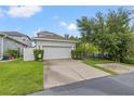 Exterior shot showcasing a well-maintained two-car garage, lush lawn and driveway at 702 34Th N Ave, St Petersburg, FL 33704