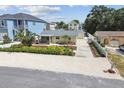 Overhead shot of home with manicured landscaping, complemented by the driveway and neighborhood at 807 Illinois Ave, Palm Harbor, FL 34683