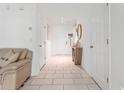 Inviting entryway with tiled floor, decorative mirror and access to living areas at 8415 Edgewater Place Blvd, Tampa, FL 33615