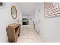 Bright entryway with tile flooring, decorative mirror, and accent table at 8415 Edgewater Place Blvd, Tampa, FL 33615