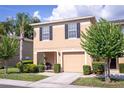 Inviting townhome with a one-car garage, well-kept lawn, and cozy covered porch at 8415 Edgewater Place Blvd, Tampa, FL 33615