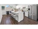 Bright kitchen with stainless steel appliances, barstool seating, and sleek white cabinetry at 851 6Th S Ave, St Petersburg, FL 33701