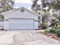 Charming single-story home featuring a two-car garage and an arched entryway at 9191 64Th N Way, Pinellas Park, FL 33782