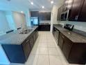 Stylish kitchen featuring granite countertops, stainless steel appliances, and dark wood cabinets at 9520 Lemon Drop Loop, Sun City Center, FL 33573