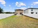Wide backyard featuring a privacy fence and an expansive lawn that extends to the back of the property at 9605 Channing Hill Dr, Sun City Center, FL 33573