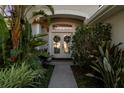 Charming entryway with double doors and lush landscaping at 10516 Gretna Green Dr, Tampa, FL 33626