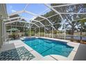Enclosed pool area with jacuzzi, outdoor seating and a view of the lake at 10709 Rockledge View Dr, Riverview, FL 33579