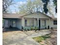 Cozy single-story home with an attached carport and a welcoming front porch at 10932 N 21St St, Tampa, FL 33612