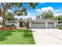 Charming single-story home with a well-maintained lawn and mature trees, plus a three car garage and long driveway at 120 Fernbrook Rd, Oldsmar, FL 34677