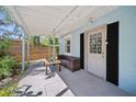 Inviting entryway with outdoor seating and a view of the fenced yard at 12304 Woodleigh Ave, Tampa, FL 33612