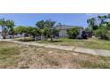 A quaint single-story house with an established front yard and concrete sidewalk in a residential neighborhood at 1242 Bermuda St, Clearwater, FL 33755