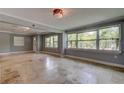 Bright, airy living room with decorative lighting, neutral paint, and expansive windows providing natural light at 1242 Bermuda St, Clearwater, FL 33755