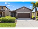 Charming single-story home featuring a well-manicured lawn and a two-car garage at 1321 Custer Bayou St, Ruskin, FL 33570