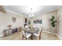 A cozy dining room with a round table, chandelier, and decorative accents creating an inviting space at 13903 Sage Thrasher Ln, Riverview, FL 33579
