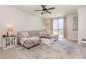 Comfortable living room with a plush sectional sofa, stylish rug, and sliding glass doors to the patio at 13958 Richland Gulf Cir, Parrish, FL 34219