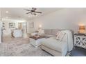 Spacious living room featuring an open layout, seamlessly connected to the kitchen with an island bar at 13958 Richland Gulf Cir, Parrish, FL 34219