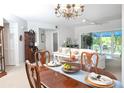 Open dining area with elegant furnishings and views of the spacious living room at 14840 Shipwatch Trce # 1924, Largo, FL 33774