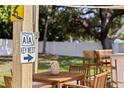 Cozy outdoor dining area with a wooden table and chairs, next to a sign pointing to Key West at 1579 Bayshore Blvd, Dunedin, FL 34698