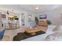 Bright living room featuring hardwood floors, stylish decor, and a smooth transition to the dining area at 1579 Bayshore Blvd, Dunedin, FL 34698