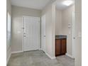 Inviting entryway with tile flooring, a storage closet, and a convenient cabinet, providing a welcoming transition into the home at 16016 Persimmon Grove Dr, Lithia, FL 33547