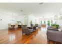 Spacious living room features gleaming wood floors, neutral paint, and ample seating at 20403 Sultana Ct, Tampa, FL 33647