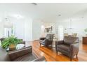 Bright open-concept living space with wood flooring flowing into the kitchen area at 20403 Sultana Ct, Tampa, FL 33647