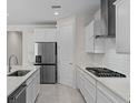 Spacious kitchen with stainless appliances, including a gas cooktop, and ample counter space at 2280 Long Spur, Odessa, FL 33556