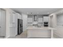 Modern kitchen with white cabinets, stainless steel appliances, and large center island at 2280 Long Spur, Odessa, FL 33556