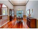 Formal dining room featuring hardwood floors, elegant lighting, and detailed trim at 2417 Valrico Forest Dr, Valrico, FL 33594