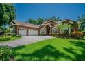 Beautiful home featuring lush landscaping, a three car garage, and an inviting front yard at 2417 Valrico Forest Dr, Valrico, FL 33594